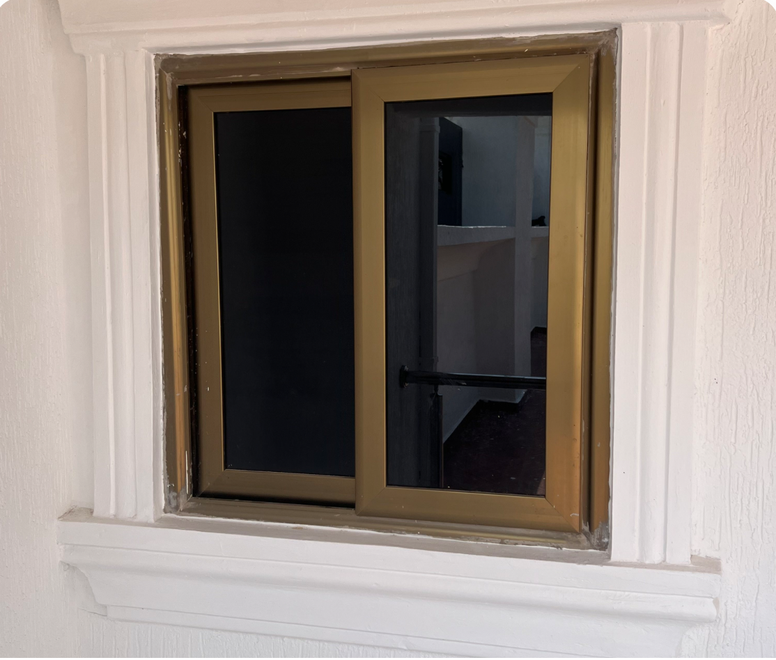 Small Golden Frame Tinted Sliding Glass Window